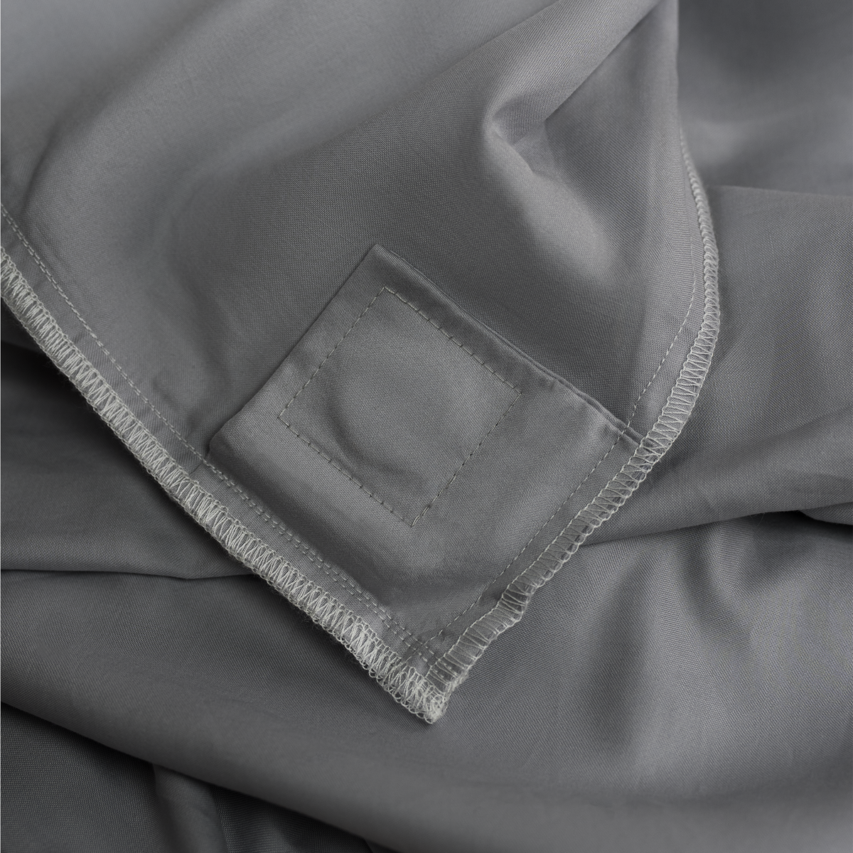Inside of the Quiet Grey duvet cover showing the sewn-in magnetic attachment patch