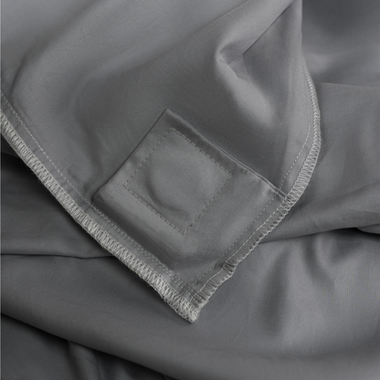 Inside of the Quiet Grey duvet cover showing the sewn-in magnetic attachment patch