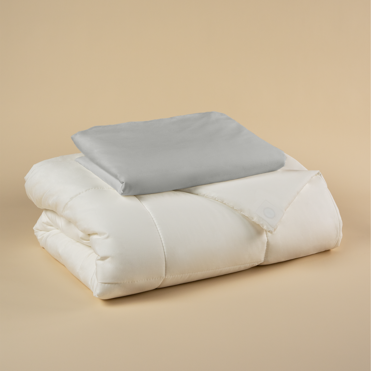 Tureis Magnetic Duvet System Set with the Quiet Grey cover folded on top of the duvet insert